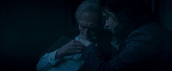Movie still from “The Exception” (2016), directed by David Leveaux – An older man and a younger woman are looking at each other; Close Up shot, High angle