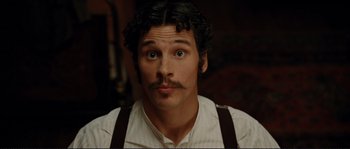Movie still from “The Extraordinary Adventures of Adèle Blanc-Sec” (2010), directed by Luc Besson – A person with a mustache wearing suspenders; Close Up shot, Low angle