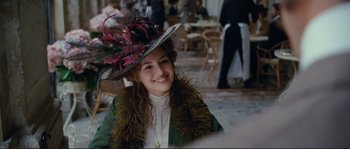Movie still from “The Extraordinary Adventures of Adèle Blanc-Sec” (2010), directed by Luc Besson – A woman wearing a hat and a green jacket; Medium shot, Over the shoulder angle