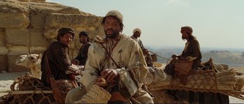 Movie still from “The Extraordinary Adventures of Adèle Blanc-Sec” (2010), directed by Luc Besson – A group of men sitting on top of a hill; Medium shot, Low angle