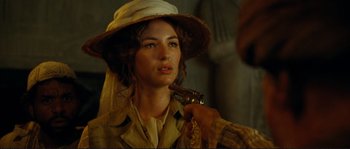 Movie still from “The Extraordinary Adventures of Adèle Blanc-Sec” (2010), directed by Luc Besson – A woman with a hat and a gun in her mouth; Close Up shot, Over the shoulder angle