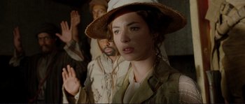 Movie still from “The Extraordinary Adventures of Adèle Blanc-Sec” (2010), directed by Luc Besson – A group of people standing next to each other in a room; Close Up shot, Over the shoulder angle