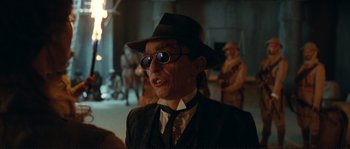 Movie still from “The Extraordinary Adventures of Adèle Blanc-Sec” (2010), directed by Luc Besson – An old man wearing a hat and sunglasses; Close Up shot, Over the shoulder angle