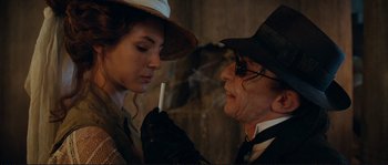 Movie still from “The Extraordinary Adventures of Adèle Blanc-Sec” (2010), directed by Luc Besson – A man and a woman are smoking a cigarette together; Close Up shot, Over the shoulder angle