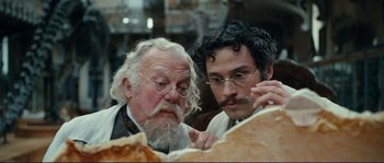 Movie still from “The Extraordinary Adventures of Adèle Blanc-Sec” (2010), directed by Luc Besson – Two men looking at a piece of paper; Close Up shot, Low angle