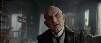 Movie still from “The Extraordinary Adventures of Adèle Blanc-Sec” (2010), directed by Luc Besson – An old man wearing a suit and a tie; Close Up shot, Low angle