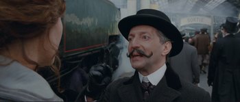 Movie still from “The Extraordinary Adventures of Adèle Blanc-Sec” (2010), directed by Luc Besson – A man in a hat and a tie; Close Up shot, Low angle