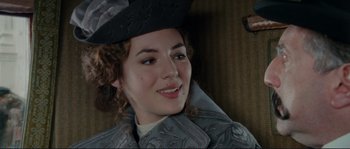 Movie still from “The Extraordinary Adventures of Adèle Blanc-Sec” (2010), directed by Luc Besson – A person wearing a hat; Close Up shot, Over the shoulder angle