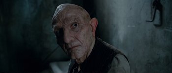 Movie still from “The Extraordinary Adventures of Adèle Blanc-Sec” (2010), directed by Luc Besson – An old man with a shaved head and a bald head; Close Up shot, Low angle