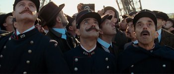 Movie still from “The Extraordinary Adventures of Adèle Blanc-Sec” (2010), directed by Luc Besson – A group of men in hats and uniforms; Close Up shot, Low angle