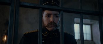 Movie still from “The Extraordinary Adventures of Adèle Blanc-Sec” (2010), directed by Luc Besson – A man in a uniform with a mustache and a beard; Close Up shot, Low angle
