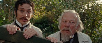 Movie still from “The Extraordinary Adventures of Adèle Blanc-Sec” (2010), directed by Luc Besson – A man and a woman standing next to each other; Close Up shot, Low angle