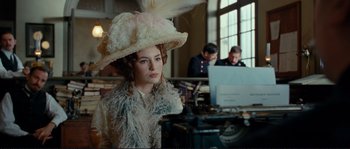 Movie still from “The Extraordinary Adventures of Adèle Blanc-Sec” (2010), directed by Luc Besson – A woman wearing a large hat and a white dress; Medium shot, Over the shoulder angle