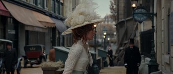 Movie still from “The Extraordinary Adventures of Adèle Blanc-Sec” (2010), directed by Luc Besson – A woman in a white dress and a white hat; Medium shot, Over the shoulder angle