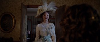 Movie still from “The Extraordinary Adventures of Adèle Blanc-Sec” (2010), directed by Luc Besson – A woman in a white dress wearing a white hat; Medium shot, Over the shoulder angle