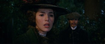 Movie still from “The Extraordinary Adventures of Adèle Blanc-Sec” (2010), directed by Luc Besson – A young woman wearing a hat and a green coat; Close Up shot, Over the shoulder angle