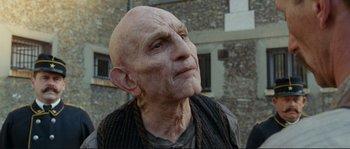 Movie still from “The Extraordinary Adventures of Adèle Blanc-Sec” (2010), directed by Luc Besson – An old man with a bald head is looking up; Close Up shot, Low angle
