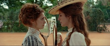 Movie still from “The Extraordinary Adventures of Adèle Blanc-Sec” (2010), directed by Luc Besson – Two young women holding tennis rackets and a cup; Close Up shot, Over the shoulder angle