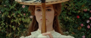 Movie still from “The Extraordinary Adventures of Adèle Blanc-Sec” (2010), directed by Luc Besson – A woman with a parasol in front of her face; Close Up shot, Low angle
