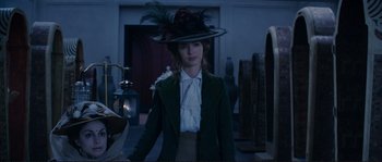 Movie still from “The Extraordinary Adventures of Adèle Blanc-Sec” (2010), directed by Luc Besson – A woman wearing a green coat and a hat; Medium shot, Over the shoulder angle