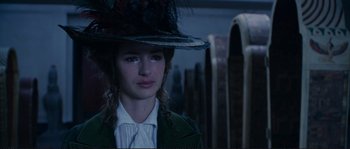 Movie still from “The Extraordinary Adventures of Adèle Blanc-Sec” (2010), directed by Luc Besson – A young woman wearing a green coat and a hat; Close Up shot, Over the shoulder angle