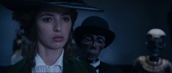 Movie still from “The Extraordinary Adventures of Adèle Blanc-Sec” (2010), directed by Luc Besson – A man and a woman are standing next to each other; Close Up shot, Over the shoulder angle