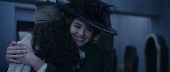 Movie still from “The Extraordinary Adventures of Adèle Blanc-Sec” (2010), directed by Luc Besson – A woman with long curly brown hair wearing a hat; Close Up shot, Over the shoulder angle