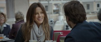 Movie still from “The Face of an Angel” (2014), directed by Michael Winterbottom – A woman sitting next to a man at a table; Close Up shot, Over the shoulder angle