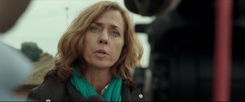 Movie still from “The Face of an Angel” (2014), directed by Michael Winterbottom – A person talking on a microphone; Close Up shot, Over the shoulder angle