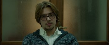 Movie still from “The Face of an Angel” (2014), directed by Michael Winterbottom – A young man with glasses and long hair; Close Up shot, Low angle