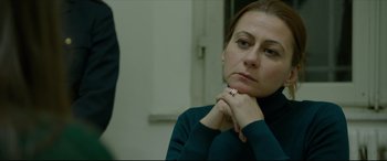 Movie still from “The Face of an Angel” (2014), directed by Michael Winterbottom – A person with her hand on her chin; Close Up shot, Over the shoulder angle