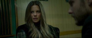 Movie still from “The Face of an Angel” (2014), directed by Michael Winterbottom – A beautiful woman with long blonde hair wearing a black jacket; Close Up shot, Over the shoulder angle