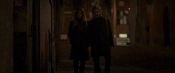 Movie still from “The Face of an Angel” (2014), directed by Michael Winterbottom – A man and a woman are walking in the dark; Medium shot, Low angle