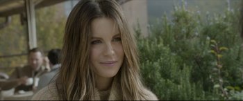 Movie still from “The Face of an Angel” (2014), directed by Michael Winterbottom – A person with long brown hair; Close Up shot, Over the shoulder angle