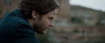 Movie still from “The Face of an Angel” (2014), directed by Michael Winterbottom – A person smoking a cigarette; Close Up shot, Over the shoulder angle