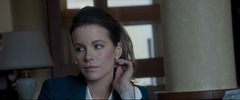 Movie still from “The Face of an Angel” (2014), directed by Michael Winterbottom – A woman putting on her earrings while sitting in a chair; Close Up shot, Over the shoulder angle