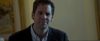 Movie still from “The Face of an Angel” (2014), directed by Michael Winterbottom – A person wearing a suit and tie; Close Up shot, Over the shoulder angle