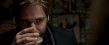 Movie still from “The Face of an Angel” (2014), directed by Michael Winterbottom – A person holding a piece of food; Close Up shot, Over the shoulder angle