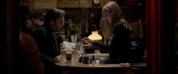 Movie still from “The Face of an Angel” (2014), directed by Michael Winterbottom – A man and a woman at a counter; Medium shot, Over the shoulder angle