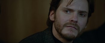 Movie still from “The Face of an Angel” (2014), directed by Michael Winterbottom – A person with a beard; Close Up shot, Over the shoulder angle