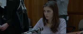 Movie still from “The Face of an Angel” (2014), directed by Michael Winterbottom – A woman with long hair is holding a microphone; Close Up shot, Over the shoulder angle