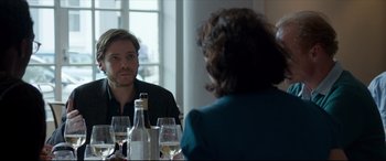 Movie still from “The Face of an Angel” (2014), directed by Michael Winterbottom – A man and a woman sitting at a table with wine glasses; Close Up shot, Over the shoulder angle