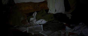 Movie still from “The Face of an Angel” (2014), directed by Michael Winterbottom – A glass of water is sitting on the floor next to a messy bed; Medium shot, High angle
