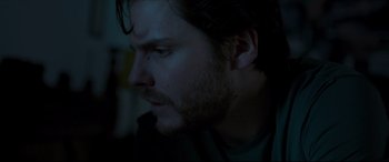 Movie still from “The Face of an Angel” (2014), directed by Michael Winterbottom – A person with a beard; Close Up shot, Over the shoulder angle