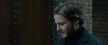 Movie still from “The Face of an Angel” (2014), directed by Michael Winterbottom – A person with long hair and a beard; Close Up shot, Over the shoulder angle
