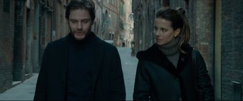 Movie still from “The Face of an Angel” (2014), directed by Michael Winterbottom – A man and a woman walking down a street; Medium shot, Low angle