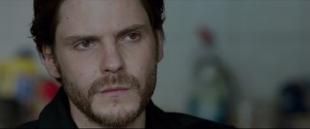 Movie still from “The Face of an Angel” (2014), directed by Michael Winterbottom – A person with a beard; Close Up shot, Over the shoulder angle