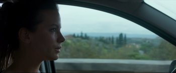 Movie still from “The Face of an Angel” (2014), directed by Michael Winterbottom – A woman looking out the window of a car; Close Up shot, Low angle