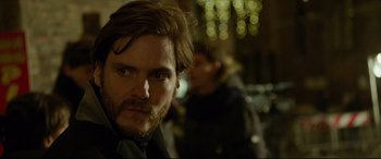 Movie still from “The Face of an Angel” (2014), directed by Michael Winterbottom – A person with a beard; Close Up shot, Over the shoulder angle