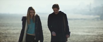 Movie still from “The Face of an Angel” (2014), directed by Michael Winterbottom – A man and a woman walking on the beach; Medium shot, Over the shoulder angle